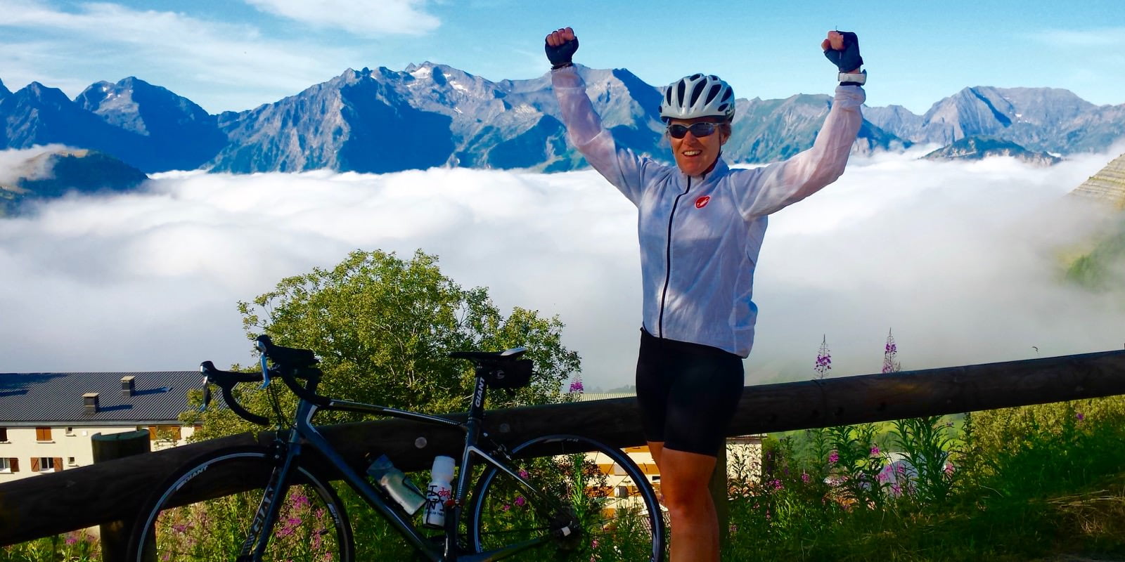 Conquered Alpe d'Huez woman above the clouds